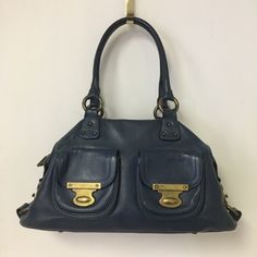 The Classic Leather Hobo Tote From Marc Jacobs. Navy Leather With Brass Hardware. Two Front Pockets With Closures. Zipper Top Closure. Suede Leather Interior With A Zippered Pocket And Two Open Pockets. In Great Condition, A Little Wear On The Hardware And Edges Of The Straps Around The Hardware. Some Stains Inside The Purse Too. Comes With Dust Bag. Formal Blue Shoulder Bag With Metal Hardware, Blue Leather Shoulder Bag With Branded Hardware, Brass Hardware Satchel Shoulder Bag For Shopping, Blue Leather Satchel With Branded Hardware, Blue Satchel Shoulder Bag With Palladium Hardware, Blue Satchel With Palladium Hardware, Blue Leather Shoulder Bag With Palladium Hardware, Blue Leather Bags With Branded Hardware, Blue Leather Shoulder Bag With Gold-tone Hardware