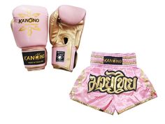 two pink and gold boxing gloves with the word kanong written on it, next to each other