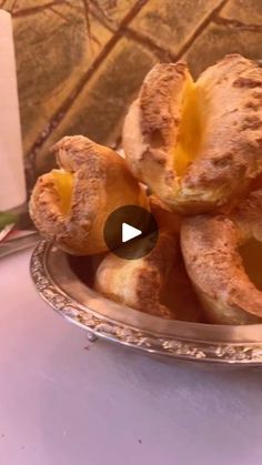 a silver plate filled with pastries on top of a table