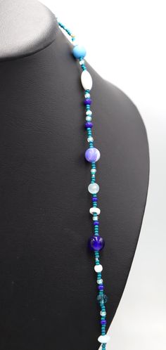 This Necklace with Blue You Away – Blue and White 38” Long Party Necklace by Monkey’s Mojo Southern statement necklace meets the fun and easy wear of light weight and cool glass. Inspired by the fun and festive beads thrown off Mardi Gras floats, this necklace is the perfect touch to complete any outfit. Limited 1 or 1. We couldn’t replicate this necklace if we tired. Materials Used: 11/0 Assorte4d Blue (Teal) and Silver Glass Beads 8/0 Assorted Aqua, Blue, and White Beads 6.5mm/8.4mm White Glas Blue Long Glass Necklace, Blue Glass Beaded Chain Jewelry, Blue Glass Beaded Bohemian Necklace, Blue Glass Bohemian Beaded Necklaces, Blue Single Strand Long Beaded Necklace, Bohemian Blue Glass Beaded Necklaces, Long Blue Necklace For The Beach, Blue Long Necklace For Beach, Blue Adjustable Long Necklace