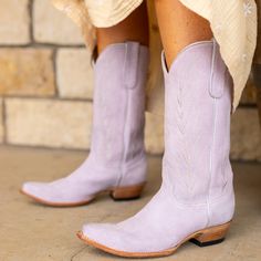 The KARIMA cowgirl boot for women is a gorgeous addition to any ensemble. Made of soft, luxurious suede in a beautiful lilac color, you'll feel pretty and confident every time you slip them on. Perfect for any occasion, these boots will make a statement wherever you go. Purple Snip Toe Boots For Fall, Purple Leather Spring Boots, Spring Purple Leather Boots, Fitted Purple Western Boots, Fitted Western Purple Boots, Chic Purple Boots For Fall, Purple Cowgirl Boots, Purple Cowboy Boots, Wedding Cowboy Boots