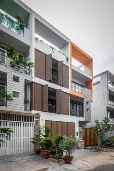 an apartment building with many balconies and plants