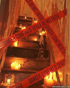 there are many candles on the stairs with caution tape around them that read danger confined space