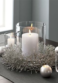 a candle and some ornaments on a table