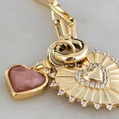 Say goodbye to small hearts and hello to BIG love with Emma - a luxe look for less! This oversized heart charm necklace in gold + silver with CZ stones makes a bold fashion statement without breaking your budget. Add extra charms to create your own unique look. Everyday Gold Plated Heart Charm, Rose Gold Plated Charm Necklaces With Heart Charm, Gold Plated Heart Charm Necklaces, Rose Gold Plated Heart Charm Necklaces, Rose Gold Heart Charm Necklace, Gold Plated, Rose Gold Plated Charm Necklace With Heart Charm, Double Heart Rose Gold Necklace With Charms, Gold Plated Heart Necklace With Charms, Everyday Heart Shape Charm Necklaces With Dangling Charms