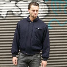 "This 1990s vintage jacket is a dark navy blue color and has a rounded wing collar that shows the brown genuine leather underside when you wear the collar turned up. The warm jacket zips closed in front and has two snap buttons to further secure it. When worn with the \"lining\" showing, you have a completely different and colorful look and feel (cotton fabric in green, tan, and fuchsia, with purple satin acetate sleeves). Note that if you want to wear the colorful side, you zip the jacket close Navy Padded Collar Outerwear For Fall, Navy Outerwear With Ribbed Collar For Fall, Wing Collar, Long Overcoat, Tweed Coat, Trench Coat Black, Purple Satin, Warm Jacket, Zipper Jacket