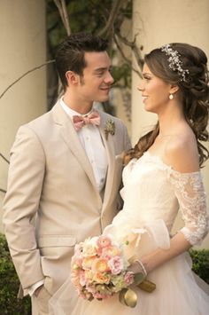 a bride and groom standing next to each other