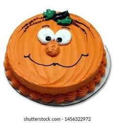 a cake decorated with an orange face and green leaves on it's head is ready to be eaten