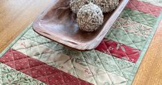 some balls are in a wooden bowl on a table