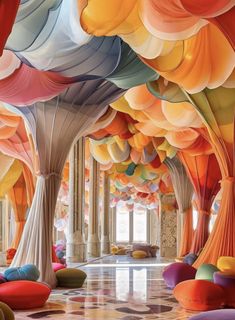 the interior of a building with many colorful balloons hanging from it's ceiling and columns