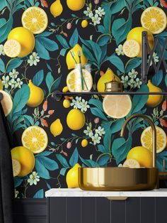 a kitchen with yellow lemons and green leaves on the wall next to a sink