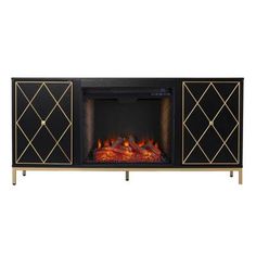 an entertainment center with a fire place in the middle and gold trimmings on it