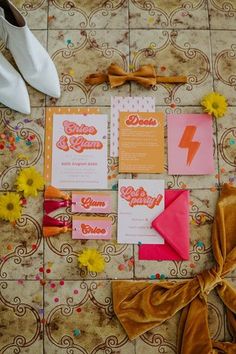 the wedding stationery is laid out on the floor