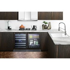 a kitchen with marble counter tops and dark wood cabinetry, along with stainless steel appliances