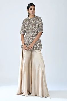 Shop for Sejal Kamdar Beige German Satin Ajrakh Print Peplum Top And Flared Pant Set for Women Online at Aza Fashions Elegant Navratri Choli With Printed Motifs, Elegant Festive Choli With Printed Motifs, Bohemian Palazzo Set With Motifs For Festive Season, Festive Bohemian Palazzo Set With Motifs, Traditional Silk Palazzo Set With Block Print, Festive Cotton Silk Palazzo Set With Block Print, Festive Block Print Cotton Silk Palazzo Set, Kalamkari Print Palazzo Set For Wedding And Navratri, Eid Semi-stitched Kalamkari Print Blouse