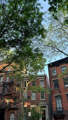 an apartment building with trees in the foreground