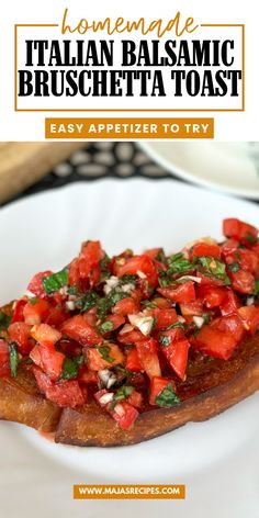 a white plate topped with pizza covered in tomato sauce and basil on top of it