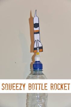 a bottle with a rocket ship on top and the words squeezey bottle rocket above it