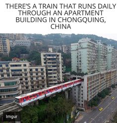 an aerial view of a city with high rise buildings and a train on the tracks