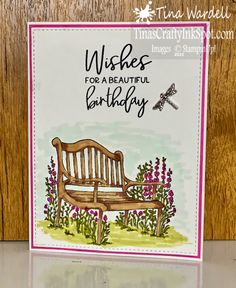 a birthday card with a wooden bench and flowers on the front, which reads wishes for a beautiful birthday