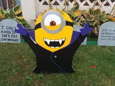 a yellow and black minion sitting in the grass next to tombstones that say i only asked if she put on weight