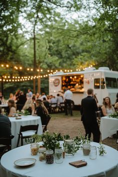 an outdoor event with food trucks and tables set up for people to enjoy the night