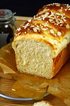 a loaf of bread sitting on top of a wooden cutting board