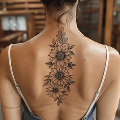 a woman with a sunflower tattoo on her back