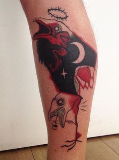 a tattoo on the leg of a person with an eagle and bird head in it