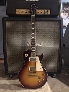 an electric guitar sitting on top of a carpeted floor