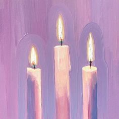 three lit candles in front of a purple background