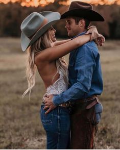 a man and woman in cowboy hats hugging