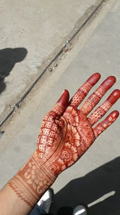 a person's hand with henna on it