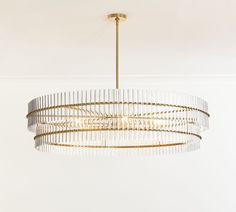 a chandelier hanging from the ceiling in a room with white walls and flooring