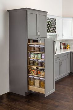 an open cabinet in the middle of a kitchen