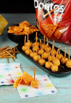 some snacks are sitting on a table with chips