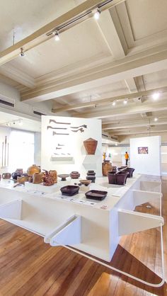 a room filled with lots of different types of bowls and pans on top of a table