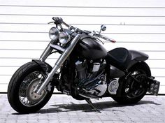 a black motorcycle parked in front of a garage door