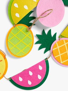 pineapple, watermelon and melon cut out from felt hanging on string