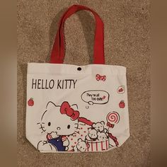 This Listing Is For A Brand New Without Tags (Bnwot) Hello Kitty Tote Bag. This Tote Bag Is Adorable! It Feels Like A Light Canvas Material. It Has An Adorable Graphic, Which Is The Same On Both Sides Of The Bag. The Tote Bag Is Red, White, Black With A Little Bit If Blue, And It Snaps Shut. The Measurements Are Shown In The Photos. Please Leave A Comment Below If You Have Any Questions. Offers Are Always Welcome! Remember To Bundle And Save! I Will Send You An Awesome Offer On Your Bundle ! Tha White Hello Kitty Bag For Daily Use, White Bag With Cat Design For Shopping, White Bag With Cat Design For Gift, White Bags With Cat Design For Everyday, Trendy White Hello Kitty Bag, White Bag With Cat Design For Daily Use, White Bags With Cat Design For Gift, White Bag With Cat Design As A Gift, Trendy White Bag With Cat Design