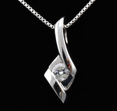 "Features * ITEM #: 4313p * METAL TYPE: 14 Karat White Gold * AVAILABLE IN: Rose Gold, Yellow Gold, White Gold * STONES USED: Diamonds * DIAMOND QTY: 1 * DIAMOND SHAPE: Round * DIAMOND CTW: .125carat * SETTING TYPE: channel set WEIGHT 1.5 gm LONG 17mm with bail Width 6.5mm * READY TO SHIP: in 3-5 Business Days FOR ADDITIONAL QUESTIONS ABOUT THIS PRODUCT: Please feel free to message us. We are quick to respond to all your inquiries. PLEASE choose as \"FAVORITE\" on the right so the item will be a Exquisite White Diamond Cut Necklace, Formal Diamond White Necklace With Polished Finish, Formal White Diamond Cut Necklace, Silver Diamond Necklace With Tension Setting For Anniversary, Elegant Diamond Solitaire Necklace With Polished Finish, White Diamond Jewelry With Polished Finish, Formal White Gold Diamond Necklace With Tension Setting, Diamond Solitaire Necklace With Polished Finish For Anniversary, Anniversary Diamond Solitaire Necklace With Polished Finish