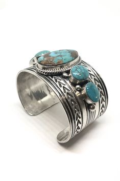 This outstanding Navajo cuff is truly a collector's piece. 5 Blue-Green Turquoise stones from a deposit near the Royston mine in Nevada is set in a row across Sterling Silver. The classic oval shaped stones running horizontally and vertically and the traditional hand-stamped designs on the sterling silver cuff make this a standout piece. The nice heavy weight of the oxidized sterling silver and the artist's attention to detail make this a piece you'll be proud to own. Hallmark "gabby" and stampe Turquoise Jewellery, Turquoise Bracelet Cuff, Jewelry Antique, Turquoise Cuff, Turquoise Stones, Sterling Silver Cuff, Oxidized Sterling Silver, American Jewelry, Green Turquoise