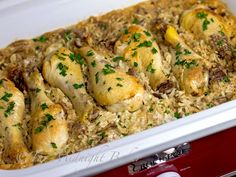 chicken and rice casserole with parsley garnish in a white dish