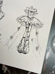 a drawing of a dress and boots on a piece of paper