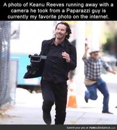 a man running down the street with a camera in his hand and another person walking behind him