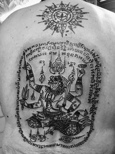 the back of a man's shoulder with an image of hindu deities on it