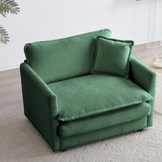 a green chair sitting on top of a white rug