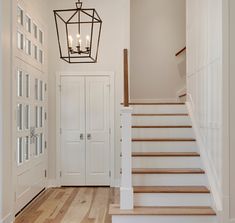 an entry way with stairs and chandelier