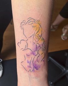 a woman's arm with a tattoo on it that has an image of a princess