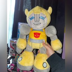 a person holding a large stuffed toy in their hand